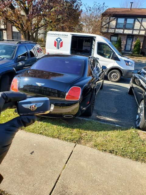 Bentley sedan beside the Mega Lock And Key van on a mobile call