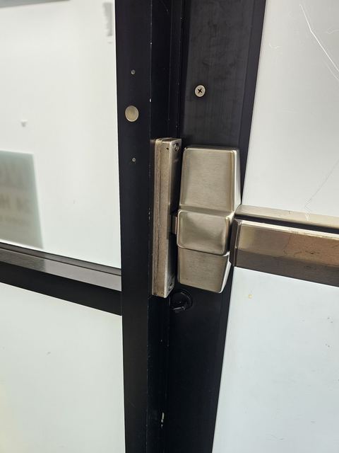 Lever lock hardware on a commercial glass door