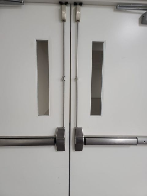Panic bar exit hardware installed on a commercial double door
